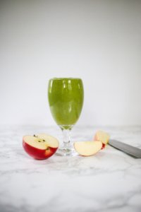 green pineapple apple smoothie in glass.