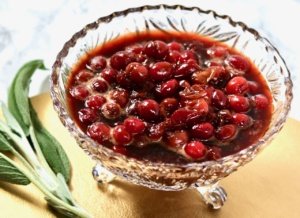 cranberry sauce in a glass bowl with gold background