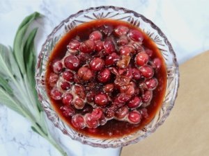 cranberry sauce in a glass bowl with gold background