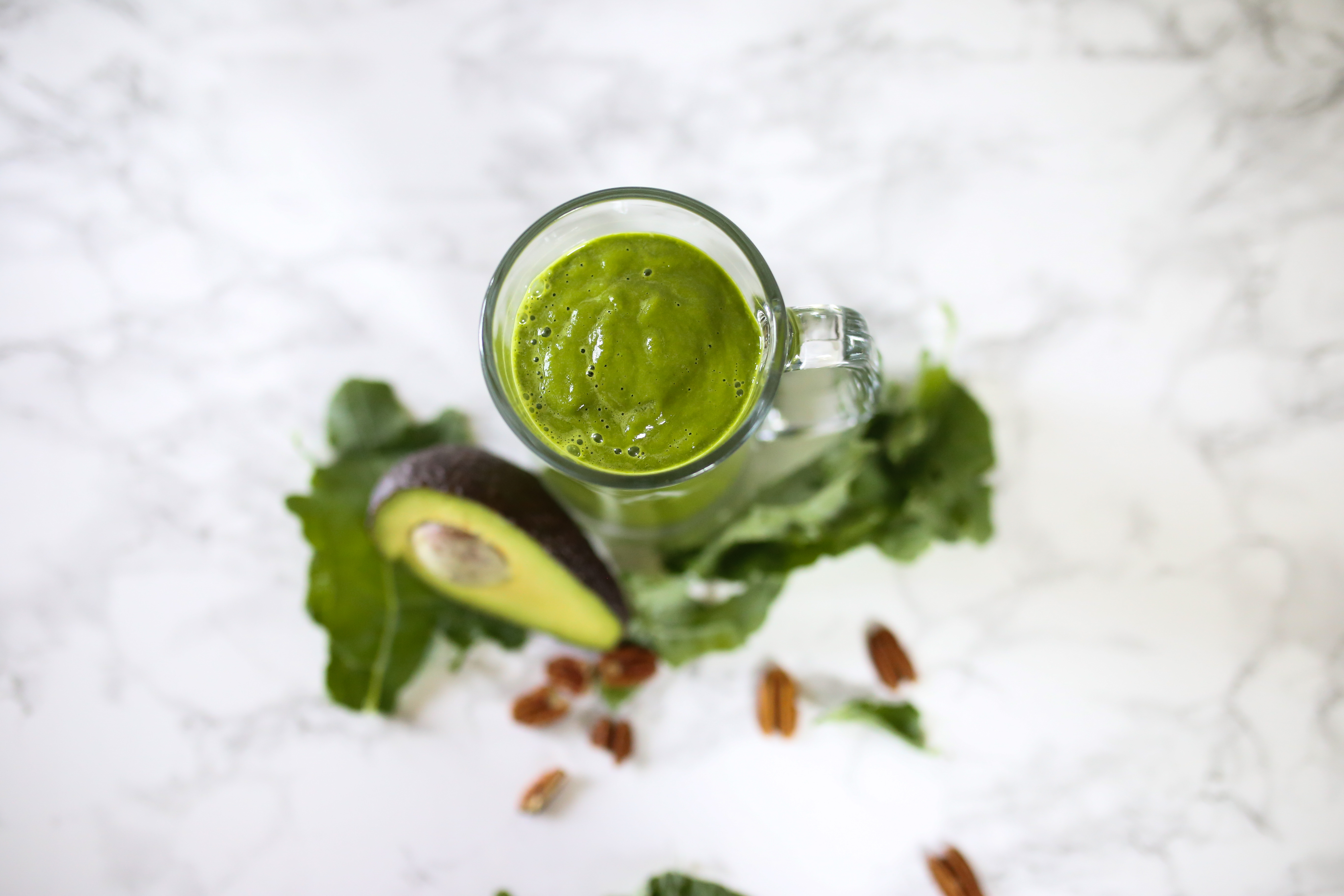 Green smoothie in glass with avacado