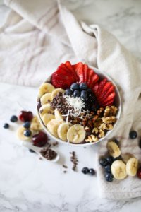 view of the top of acai bowl. Berries and nuts on top.