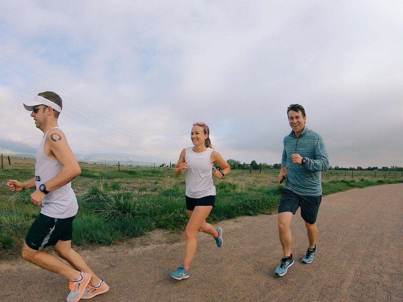 three people on a boulder colorado running trail