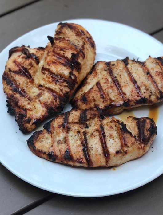 plated grilled chicken breasts