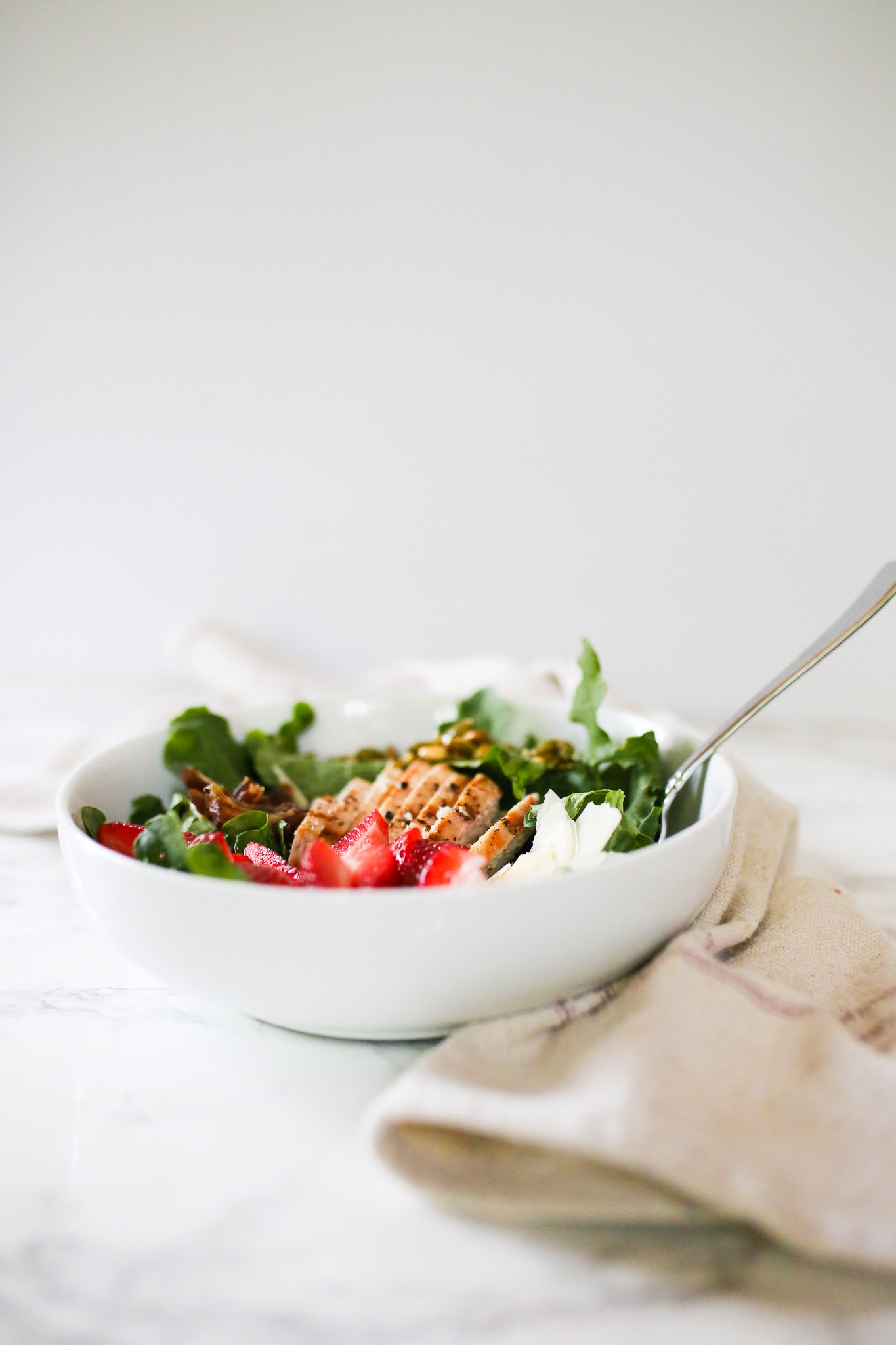 Kale Salad with Strawberries, Caramelized Pepitas, Dates & Pecorino Romano