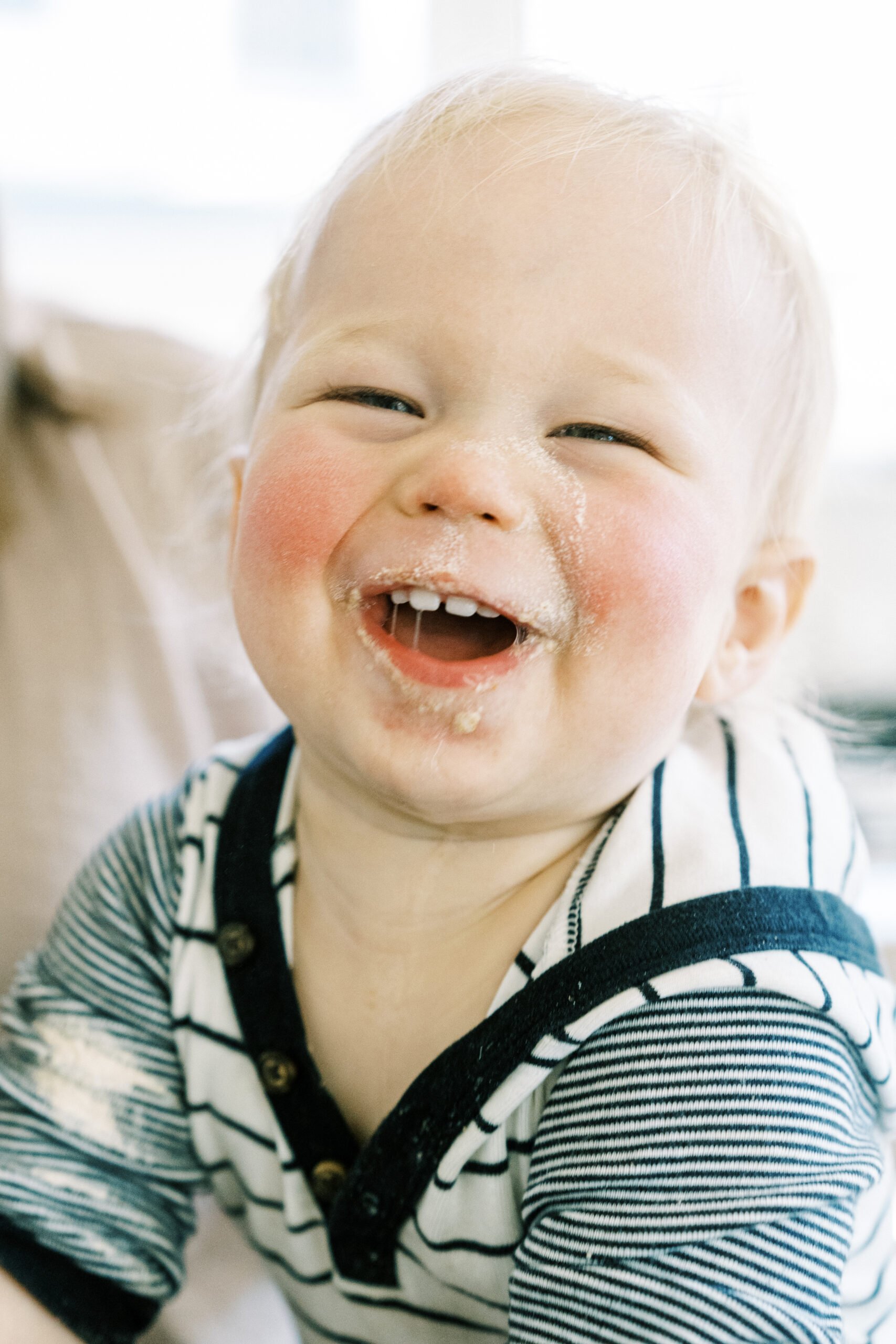 baby smiling covered in flour